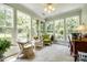 Bright sunroom with multiple windows providing natural light and views of the landscaped yard at 701 Larkridge Ct, Rock Hill, SC 29730