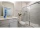 Bathroom featuring a vanity with a sink, a standard toilet and a glass enclosed shower at 711 Beaty St, Davidson, NC 28036