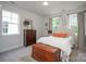 Cozy bedroom features two large windows, neutral paint, and comfortable furniture at 711 Beaty St, Davidson, NC 28036