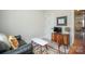 Cozy bedroom featuring a sofa, unique rug, and vintage TV cabinet, creating a welcoming and stylish space at 711 Beaty St, Davidson, NC 28036