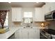 Bright kitchen features white cabinetry, stainless steel appliances, tiled backsplash and a large sink at 711 Beaty St, Davidson, NC 28036