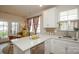 Modern kitchen with quartz countertops, stainless steel appliances, and a breakfast bar at 711 Beaty St, Davidson, NC 28036