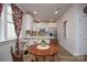 Bright eat-in kitchen with white cabinets, stainless steel appliances, and a breakfast bar at 711 Beaty St, Davidson, NC 28036
