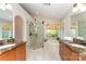 Luxurious bathroom with dual vanities, glass-enclosed shower, and a soaking tub for relaxation at 7211 Baniff Cir, Charlotte, NC 28277