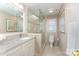 Bright bathroom with a glass-enclosed shower, granite vanity, and neutral tile flooring at 7211 Baniff Cir, Charlotte, NC 28277