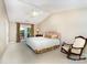Cozy bedroom with vaulted ceiling, French doors leading to patio, and comfortable rocking chair at 7211 Baniff Cir, Charlotte, NC 28277