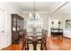 Formal dining room with elegant chandelier, wooden table, and ample seating for dinner parties at 7211 Baniff Cir, Charlotte, NC 28277