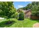 Charming brick home featuring manicured landscaping and a well-maintained lawn at 7211 Baniff Cir, Charlotte, NC 28277