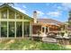 Exterior view of a brick home with a sunroom and a patio area at 7211 Baniff Cir, Charlotte, NC 28277