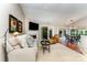 Cozy living room with a fireplace, neutral tones, and access to the sunlit breakfast area at 7211 Baniff Cir, Charlotte, NC 28277