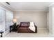 Cozy living room features natural light from windows, sofa, and accent table at 7211 Baniff Cir, Charlotte, NC 28277