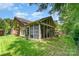 Enclosed screened porch addition on a brick home with view of a lush manicured backyard at 7211 Baniff Cir, Charlotte, NC 28277