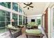 Inviting sunroom with natural light, comfortable seating, and views of the landscaped backyard at 7211 Baniff Cir, Charlotte, NC 28277