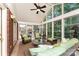 Inviting sunroom filled with natural light, comfortable seating, and views of the landscaped backyard at 7211 Baniff Cir, Charlotte, NC 28277