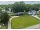 Aerial view of a home with a spacious yard, long driveway, and surrounding trees at 7901 Reames Rd, Charlotte, NC 28216
