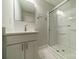 This newly updated bathroom features a modern vanity, updated shower with glass doors, and a mirrored medicine cabinet at 7901 Reames Rd, Charlotte, NC 28216