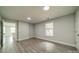 This spacious bedroom features updated gray vinyl floors, modern lighting, and natural light at 7901 Reames Rd, Charlotte, NC 28216