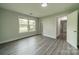 This bedroom features hard surface floors, a window, and a doorway with white trim at 7901 Reames Rd, Charlotte, NC 28216