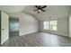 Spacious bedroom featuring high ceilings, a ceiling fan, and large windows for natural light at 7901 Reames Rd, Charlotte, NC 28216