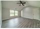 Bright bedroom with a ceiling fan, neutral walls, and two windows providing an abundance of light at 7901 Reames Rd, Charlotte, NC 28216