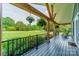 Spacious front porch with rocking chairs, wood columns, and a view of the lush green lawn at 7901 Reames Rd, Charlotte, NC 28216