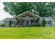 Charming gray home with a welcoming front porch and lush green lawn at 7901 Reames Rd, Charlotte, NC 28216