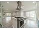 Updated kitchen features stainless steel appliances, modern lighting, and hardwood style flooring at 7901 Reames Rd, Charlotte, NC 28216