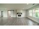 Modern living room with a barn door, fireplace, and large windows at 7901 Reames Rd, Charlotte, NC 28216