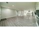 Open-concept living area with gray floors and ample natural light at 7901 Reames Rd, Charlotte, NC 28216