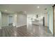 Open-concept living space with gray floors, kitchen, and modern lighting at 7901 Reames Rd, Charlotte, NC 28216
