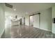 Open concept living space with white kitchen cabinets, stainless appliances, and gray flooring at 7901 Reames Rd, Charlotte, NC 28216