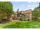Well-maintained backyard with a screened-in porch and mature trees at 7916 Wellston Dr, Charlotte, NC 28210