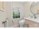 Bathroom with light wood vanity and window with natural light at 7916 Wellston Dr, Charlotte, NC 28210