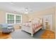 Cozy bedroom with a large window, white bed, and blue chair at 7916 Wellston Dr, Charlotte, NC 28210