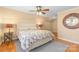 Cozy bedroom with hardwood floors, sloped ceilings, and colorful patterned bedspread at 7916 Wellston Dr, Charlotte, NC 28210