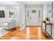 Bright entryway with hardwood floors, decorative glass door, and views into the living area at 7916 Wellston Dr, Charlotte, NC 28210