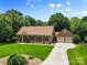 Charming brick home with a well-manicured lawn and attached garage at 7916 Wellston Dr, Charlotte, NC 28210