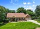 Well-maintained brick home with a manicured lawn and a two car garage at 7916 Wellston Dr, Charlotte, NC 28210