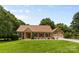Beautiful brick home with a lush green lawn and a two-car garage at 7916 Wellston Dr, Charlotte, NC 28210