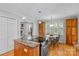 Kitchen featuring stainless steel oven, island cooktop, granite counters and adjoining breakfast nook at 7916 Wellston Dr, Charlotte, NC 28210