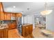 Traditional kitchen with wood cabinets, stainless appliances, and a breakfast nook at 7916 Wellston Dr, Charlotte, NC 28210