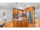 Well-lit kitchen featuring stainless steel appliances, custom cabinets, and an island with cooktop at 7916 Wellston Dr, Charlotte, NC 28210