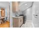 Laundry room with sink and modern washer and dryer next to dining area at 7916 Wellston Dr, Charlotte, NC 28210
