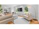 Bright living room area with large windows, comfortable seating, and contemporary decor at 7916 Wellston Dr, Charlotte, NC 28210