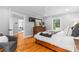 Large main bedroom with wood floors, TV, and an en suite bathroom at 7916 Wellston Dr, Charlotte, NC 28210