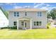 Exterior of home highlighting large backyard and covered patio with ceiling fan at 7930 Rolling Wheels Rd, Charlotte, NC 28215