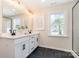 Bright bathroom with a double vanity, modern fixtures, and natural light at 7930 Rolling Wheels Rd, Charlotte, NC 28215