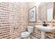 Stylish powder room featuring patterned wallpaper, pedestal sink, and decorative mirror at 7930 Rolling Wheels Rd, Charlotte, NC 28215