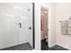 Modern bathroom featuring a glass-enclosed shower and elegant tile at 7930 Rolling Wheels Rd, Charlotte, NC 28215