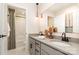 Bright bathroom features dual sinks with pendant lighting, framed mirror and decorative accents at 7930 Rolling Wheels Rd, Charlotte, NC 28215